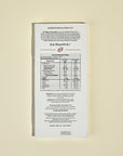 Back of a chocolate bar packaging with nutritional information and branding on a beige background. Magno chocolates