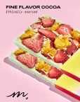 A chocolate bar with layers featuring caramelized macadamia nuts, freeze-dried strawberries, and exotic golden berries.