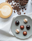 Colombian coffee grounds and artisan chocolates shown on a tabletop