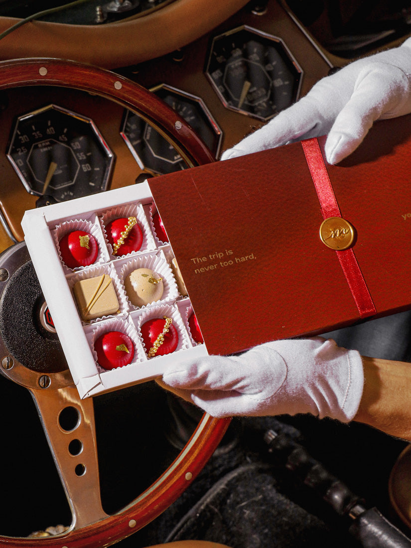 Mother's Day Chocolate Gift Box being opened with white gloved hands