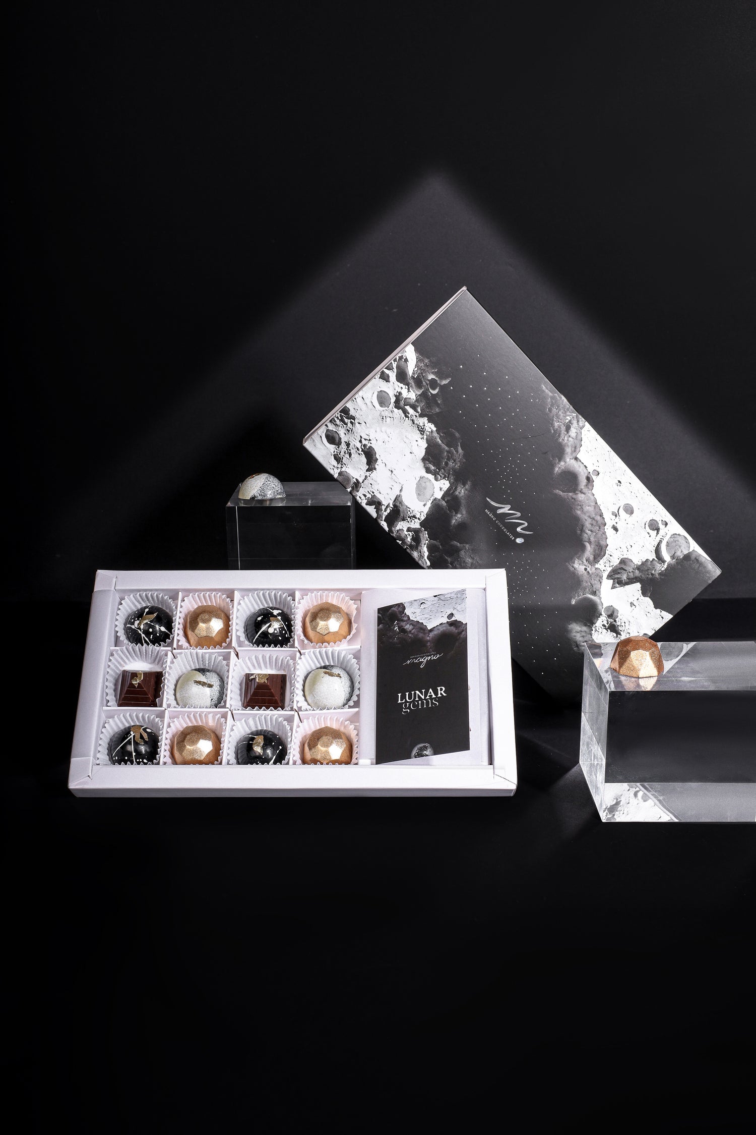 Our gourmet chocolate gift box over a dark backdrop and displaying the gorgeous hand painted bonbons