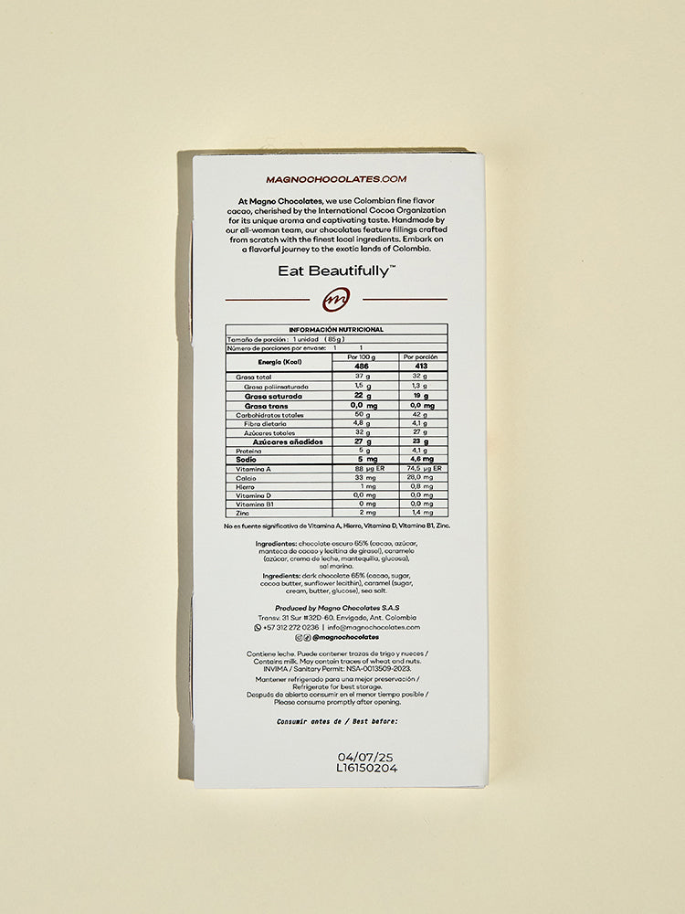 Back of a chocolate bar packaging with nutritional information and branding on a beige background. Magno chocolates