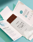Chocolate bar with packaging on a teal background = Colombian cacao