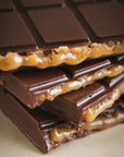 Close-up of a chocolate bar with a crumbly texture on a light background