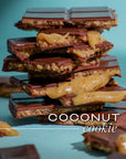 Stack of coconut cookie chocolate bars on a teal background with 'COCONUT cookie' text.