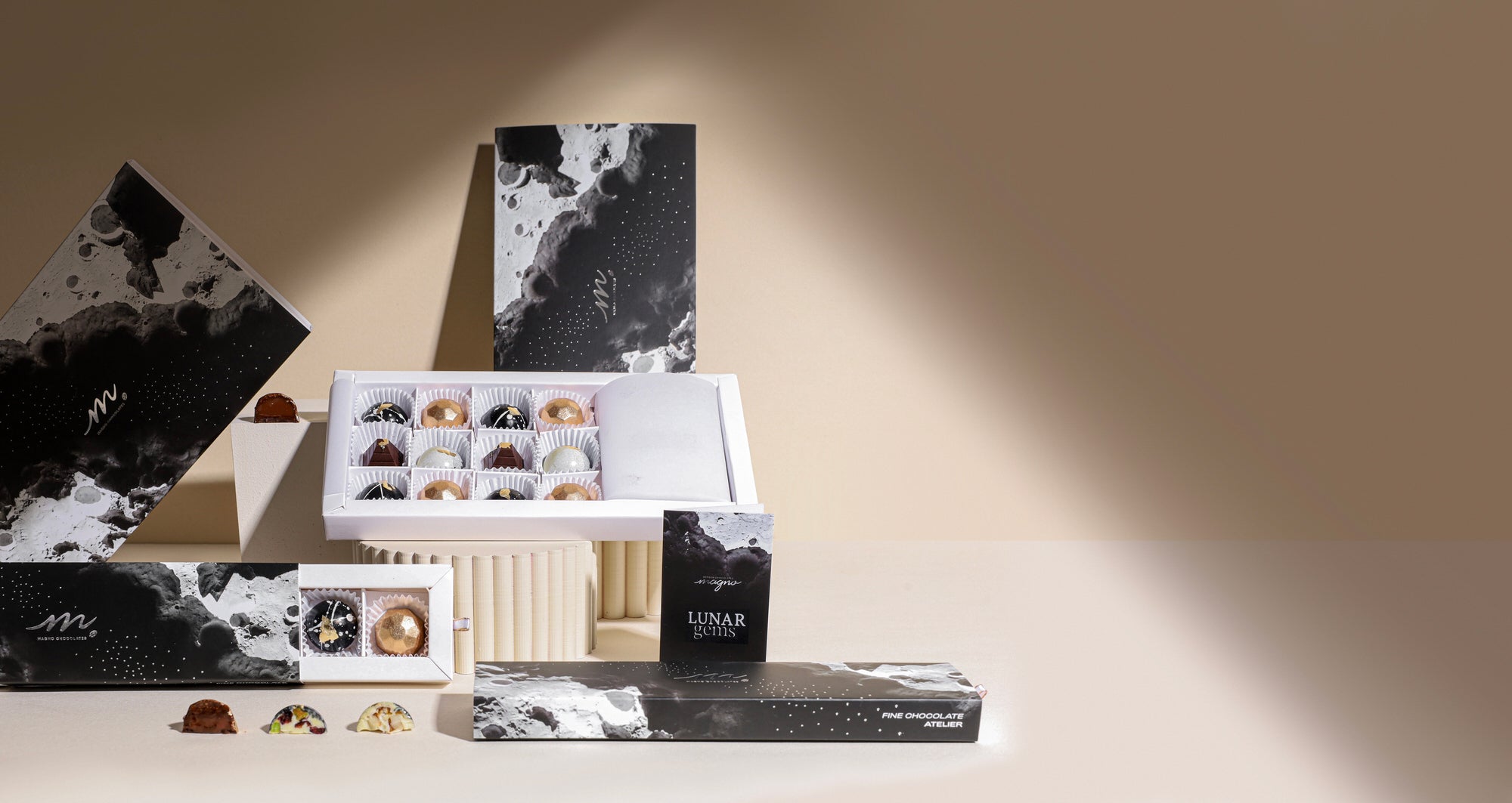 Our different presentations of the lunar gems showing their gourmet gift boxes against a studio backdrop