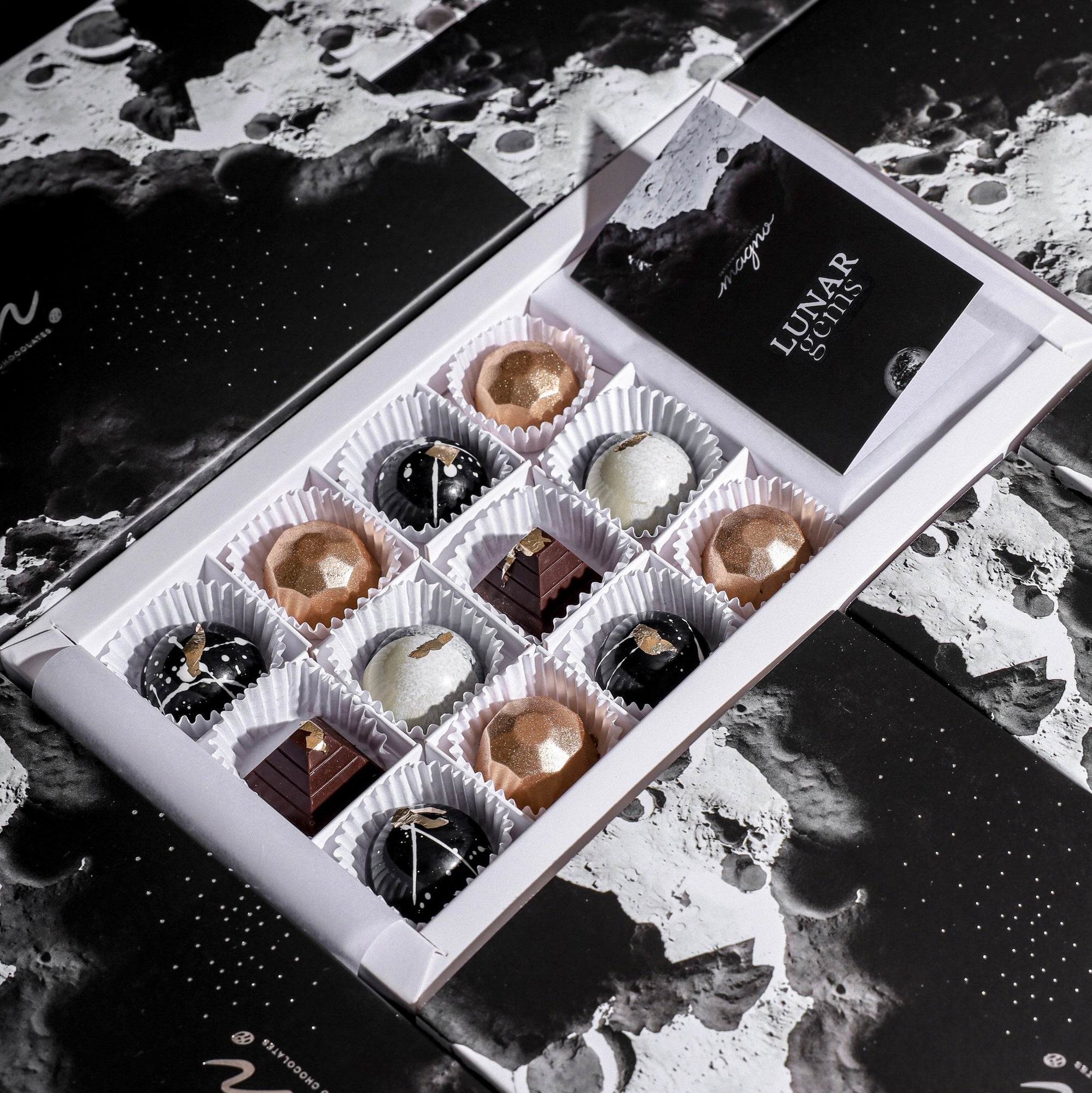 Gourmet chocolate gift box showing our hand painted "lunar gems" in their luxury packaging